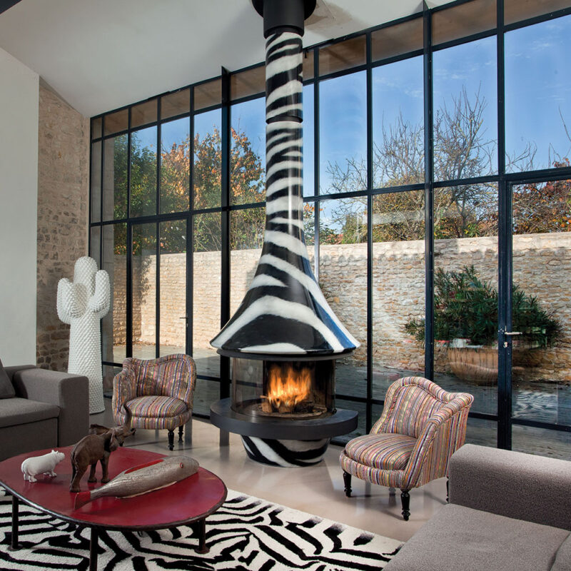 Zebra pattern JC Bordelet Eva Luxury Suspended Fireplace in a room with zebra accents.