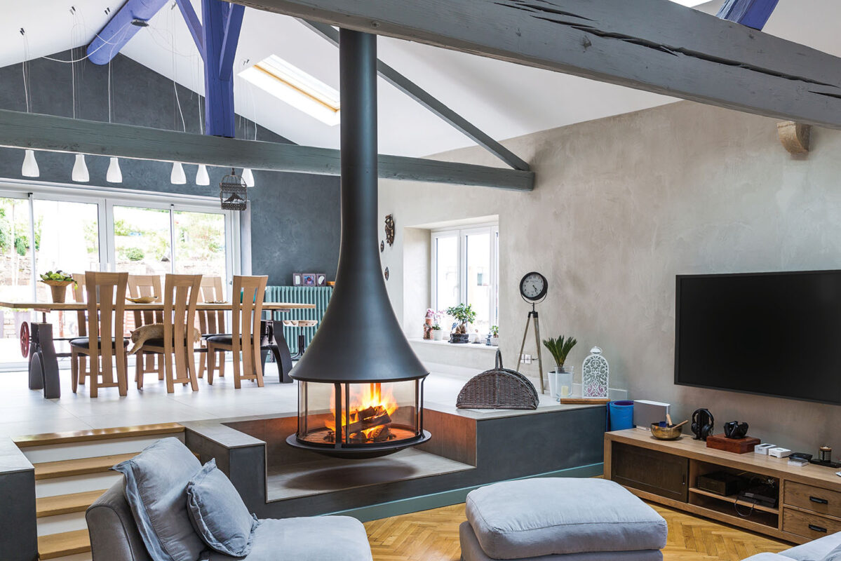 Black JC Bordelet Zelia Luxury Suspended Fireplace in a high ceiling family room.